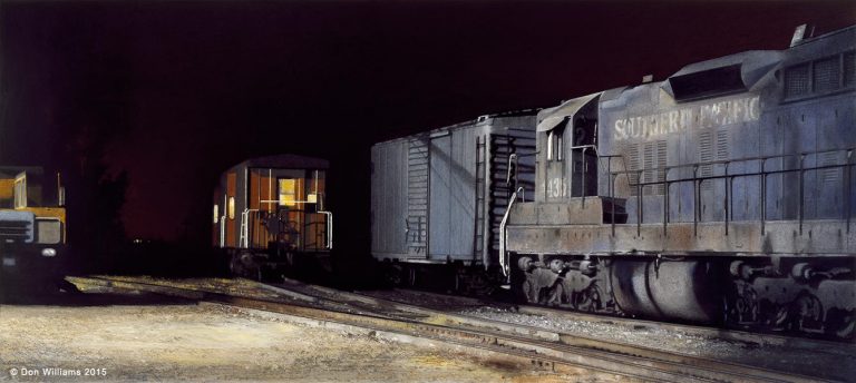 A train is on the tracks at night.